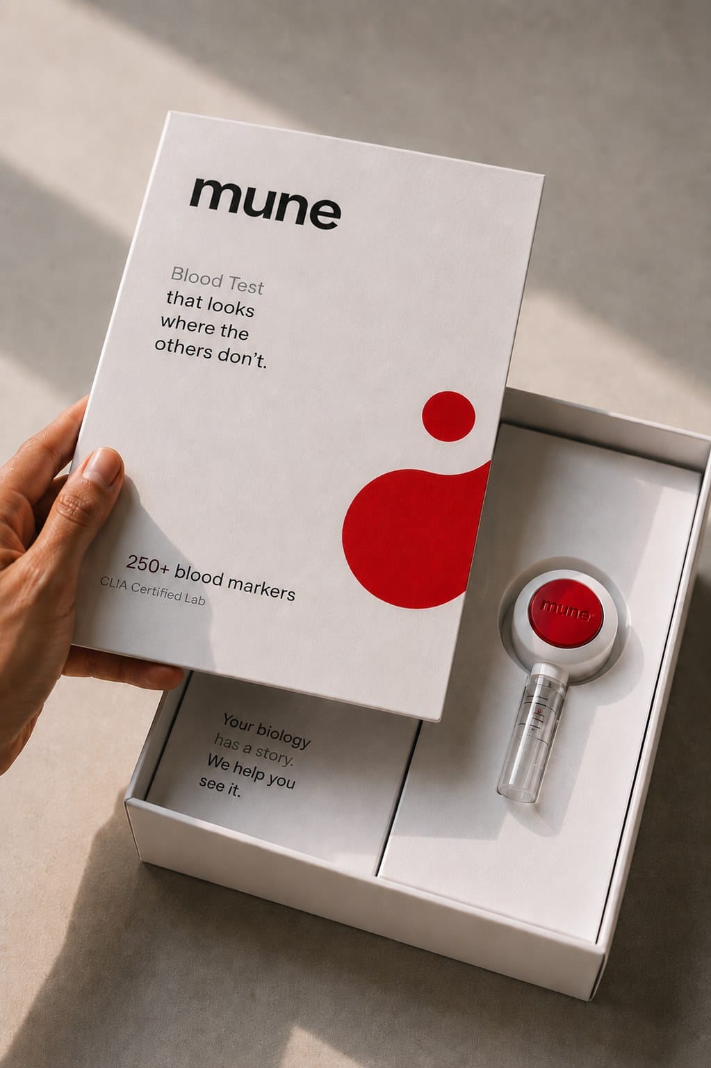 The Mune blood test kit, box open with the collection device inside