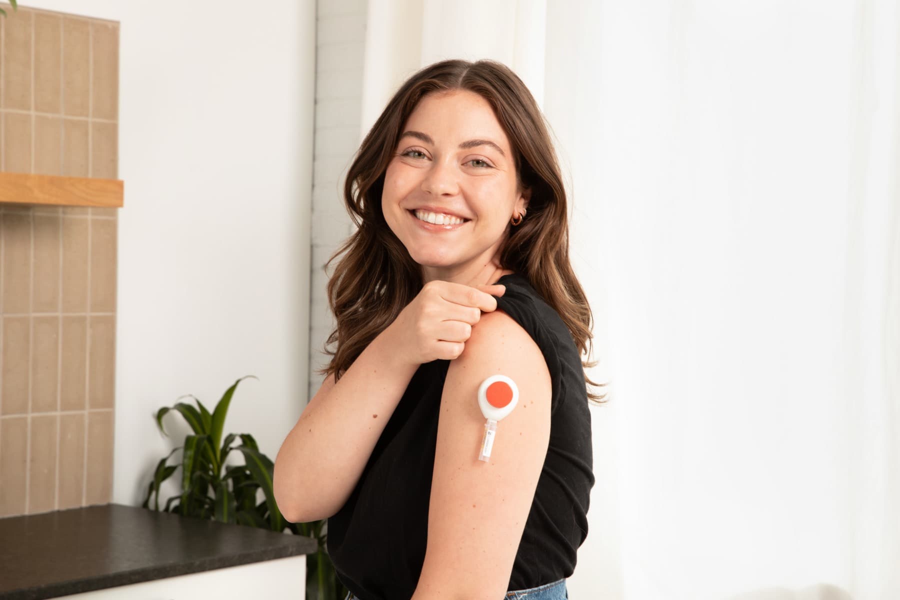 The Tasso+ at-home collection device on a person's upper arm